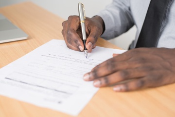 Person signing a document.